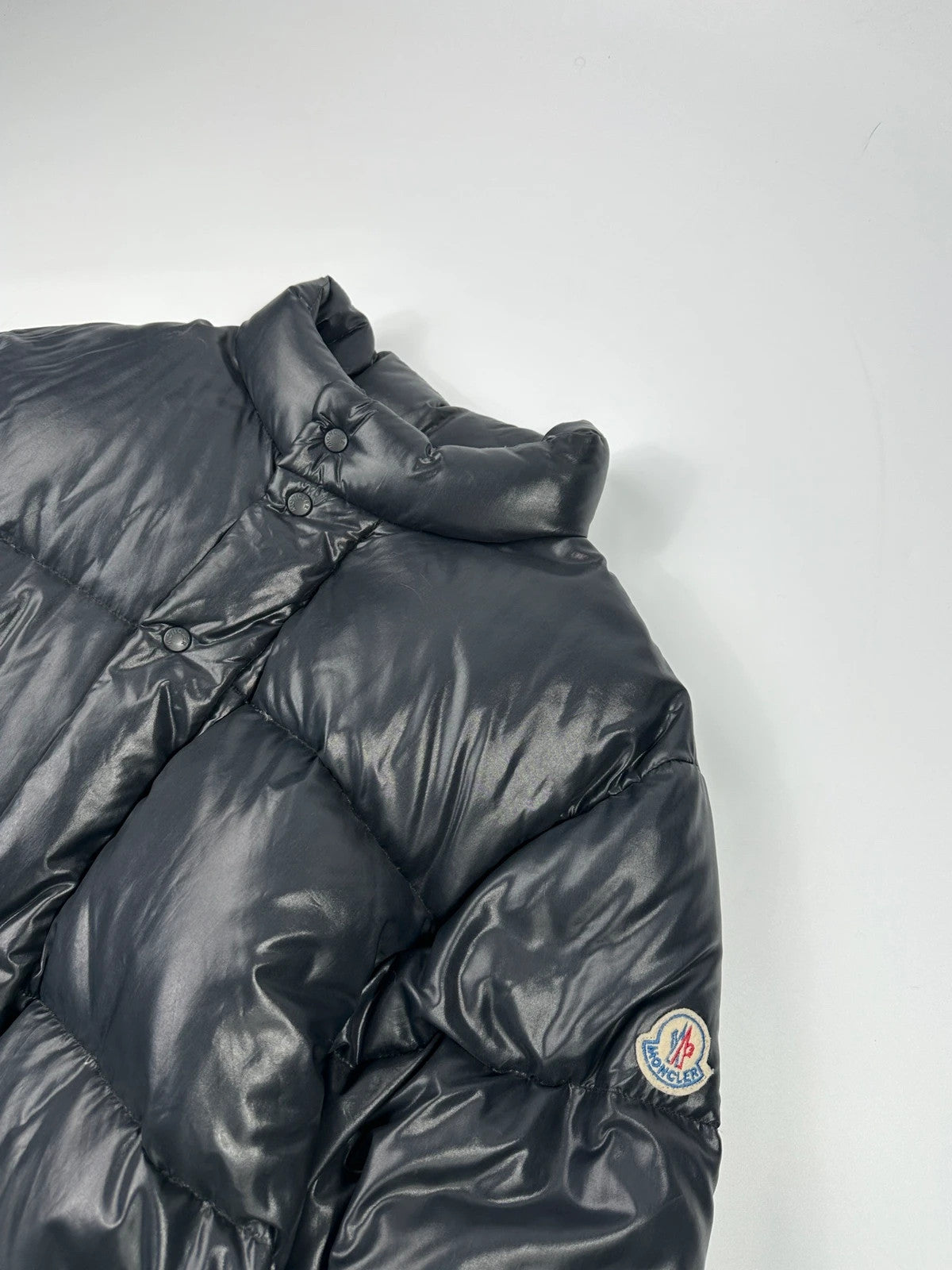 Moncler black nylon hooded puffer jacket with vintage logo and down filling.