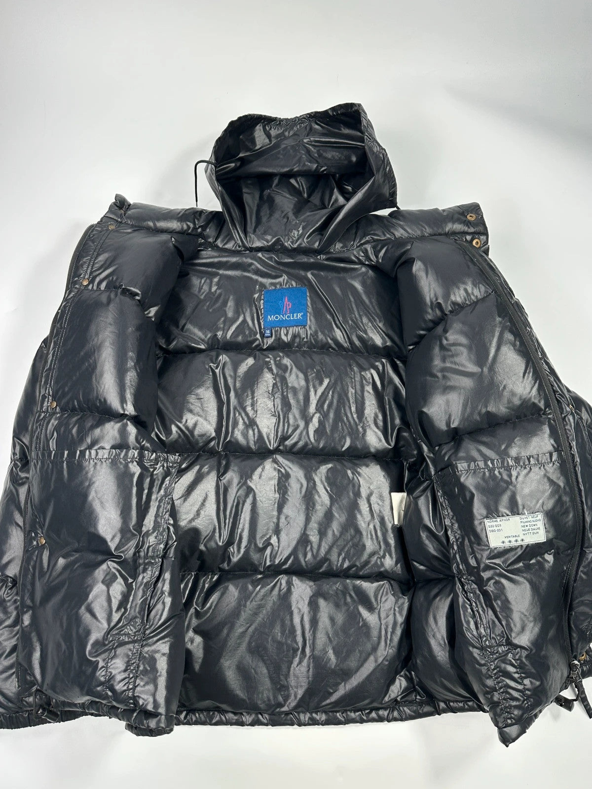 Moncler black nylon hooded puffer jacket with vintage logo and down filling.