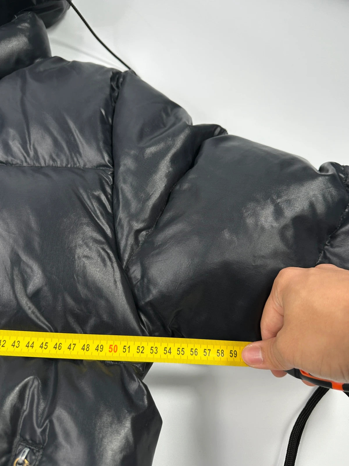 Moncler black nylon hooded puffer jacket with vintage logo and down filling.