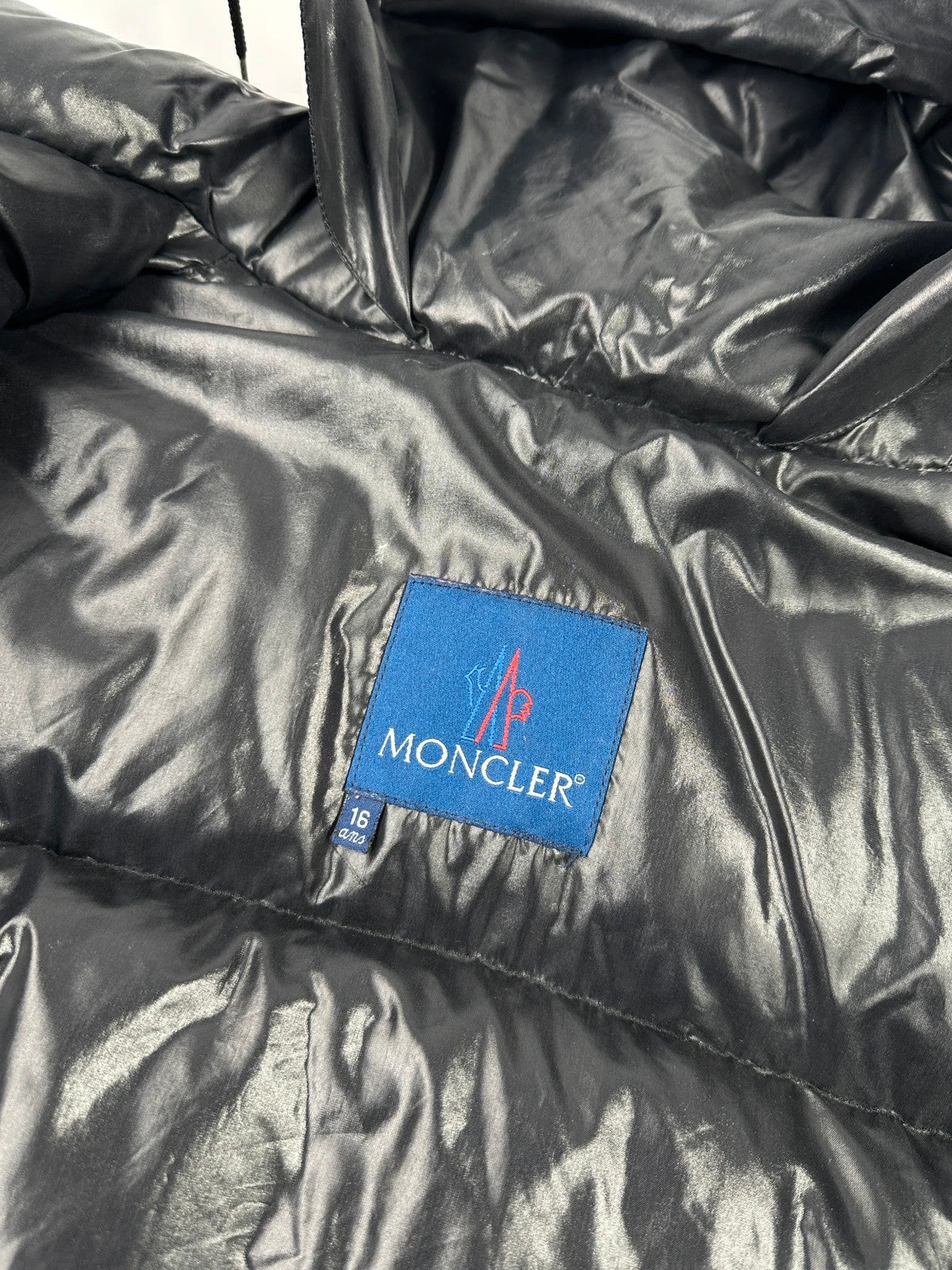 Moncler black nylon hooded puffer jacket with vintage logo and down filling.