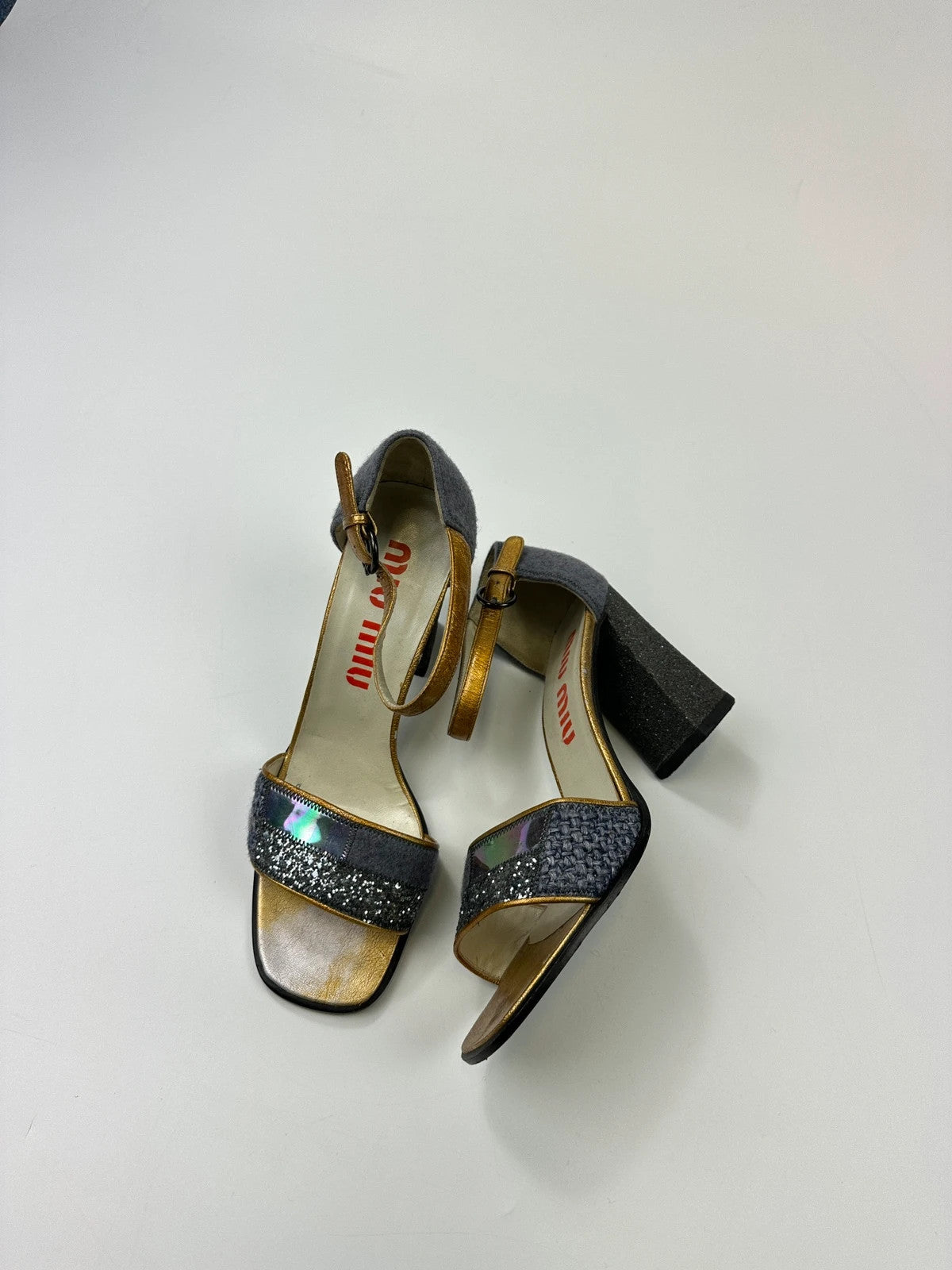 Miu Miu grey multi glitter heels with PVC coating and vintage design details.