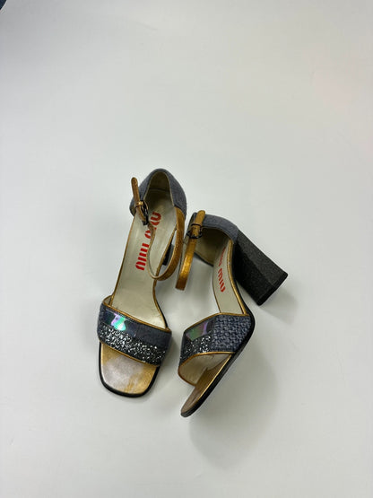 Miu Miu grey multi glitter heels with PVC coating and vintage design details.