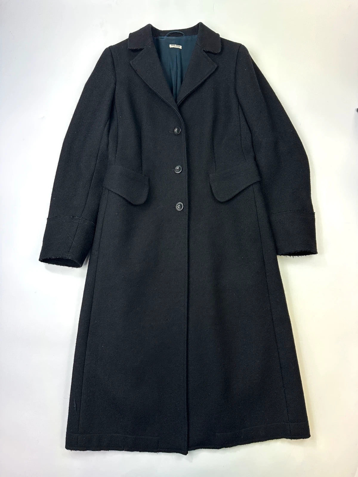 Miu Miu black wool and mohair long trench coat with vintage design and subtle wear.