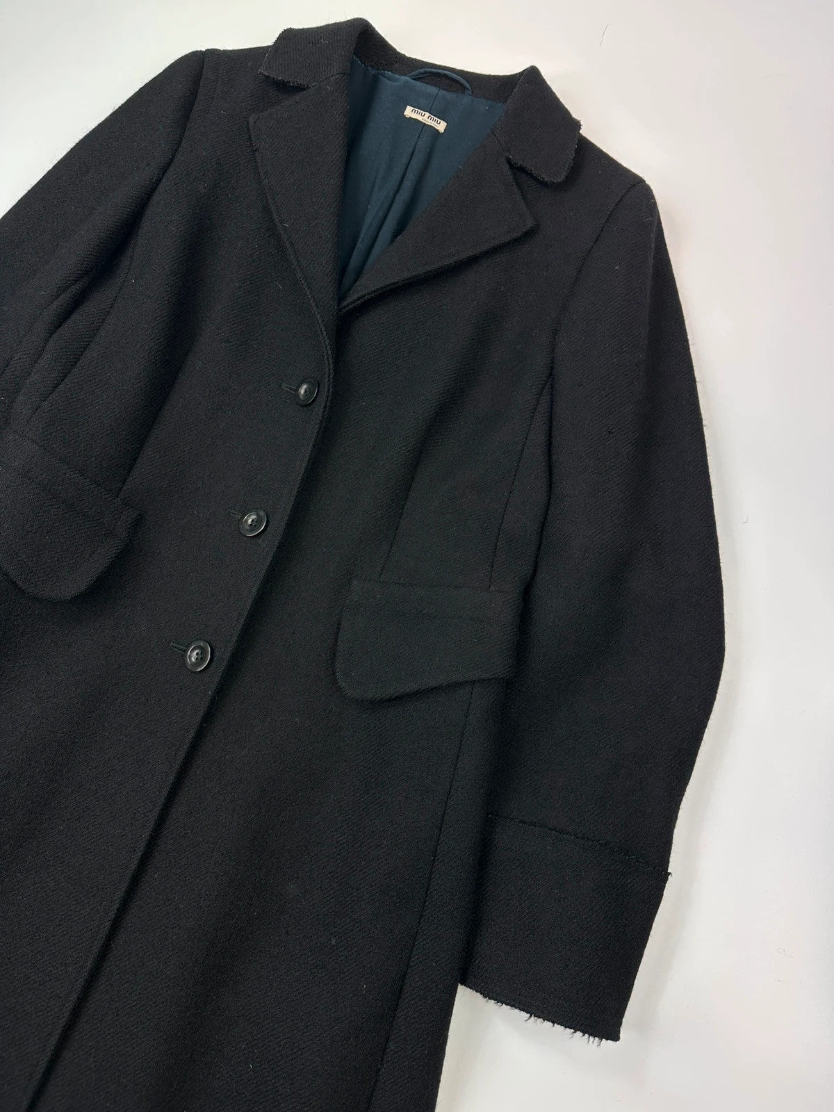 Miu Miu black wool and mohair long trench coat with vintage design and subtle wear.