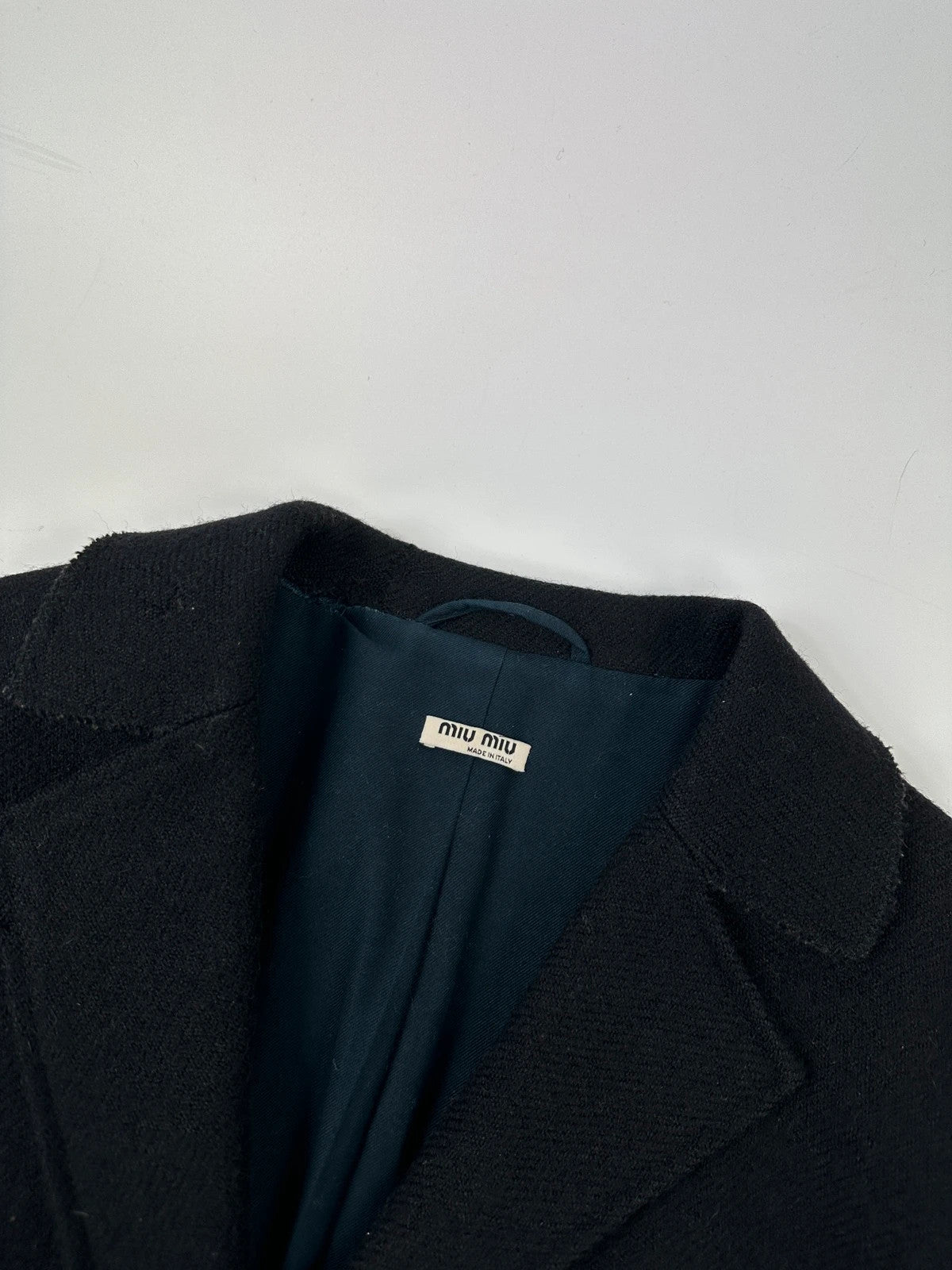 Miu Miu black trench coat in wool and mohair with vintage logo detail.