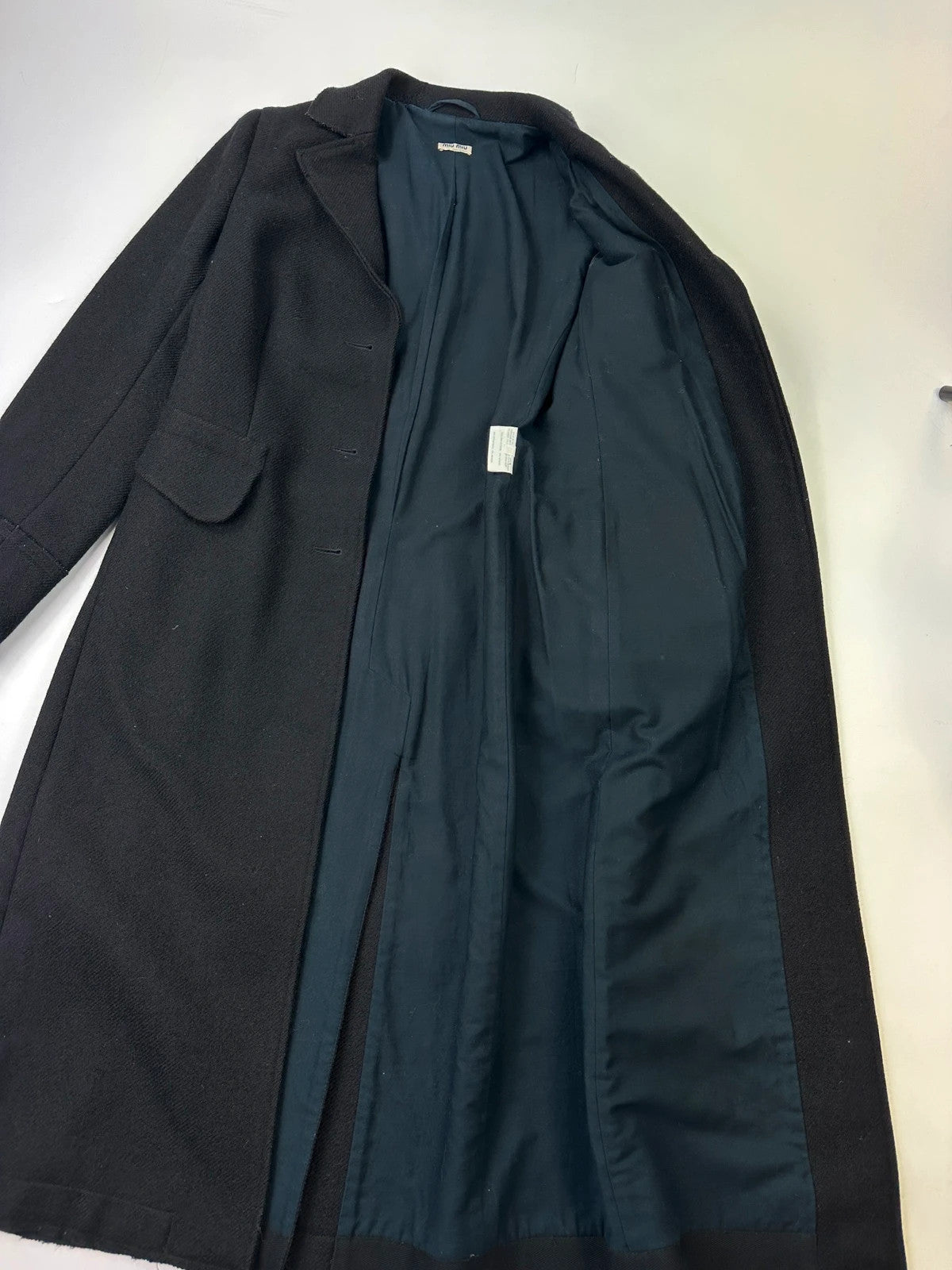 Miu Miu black trench coat in wool and mohair with vintage logo detail.