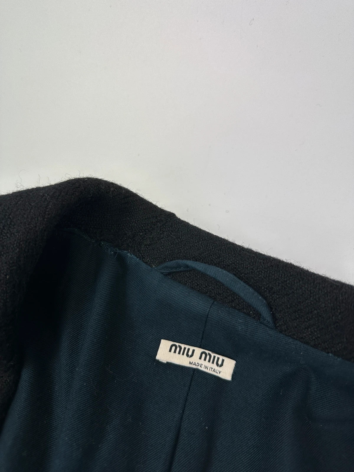 Miu Miu black trench coat in wool and mohair with vintage logo detail.