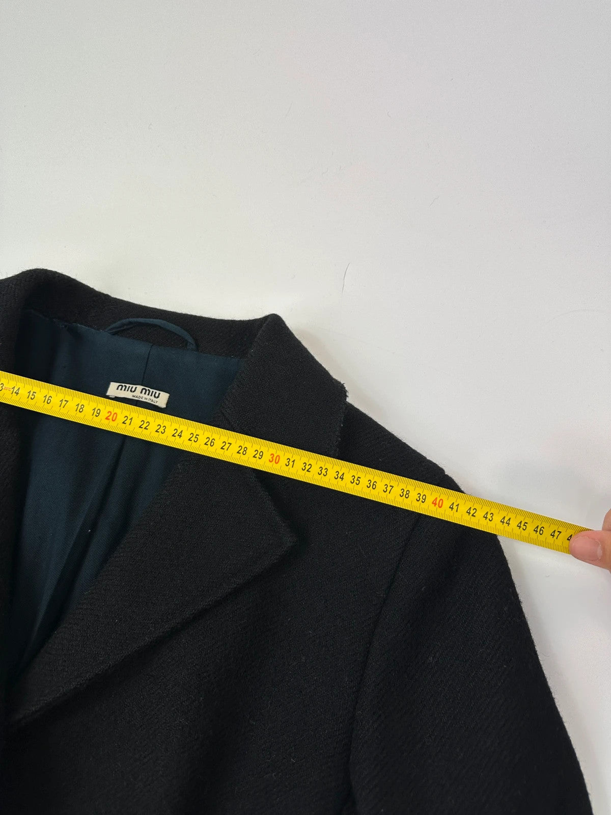 Miu Miu black trench coat in wool and mohair with vintage logo detail.