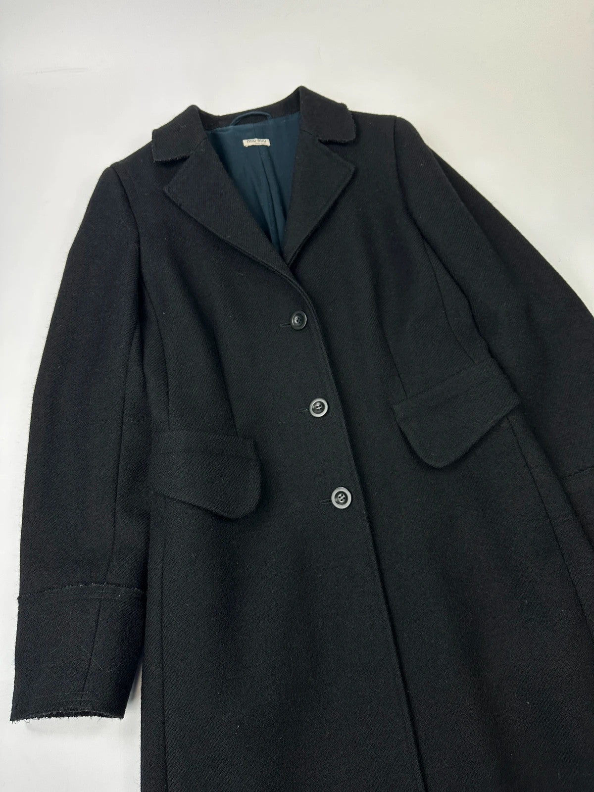 Miu Miu black trench coat in wool and mohair with vintage logo detail.