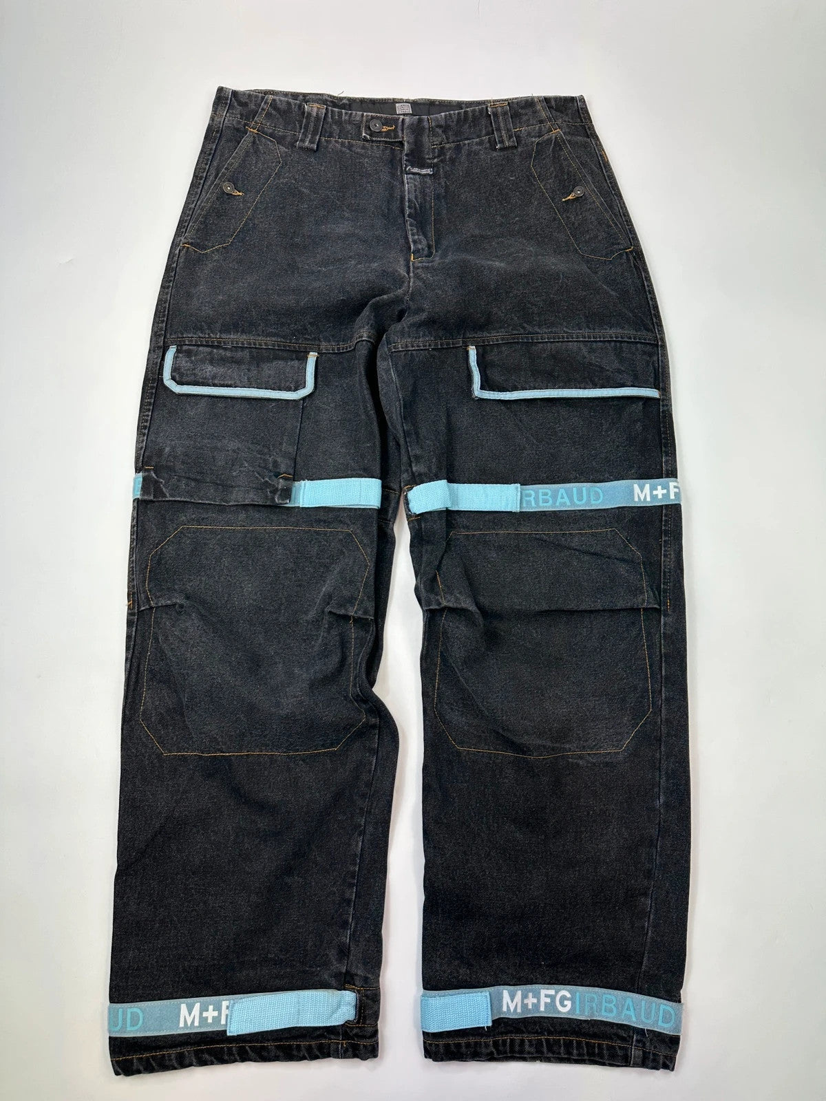 Marithé François Girbaud black wide-leg trousers with turquoise accents and cargo pockets.