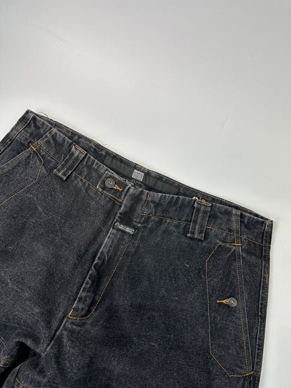 Marithé François Girbaud black and turquoise baggy denim trousers with cargo pockets and velcro details.
