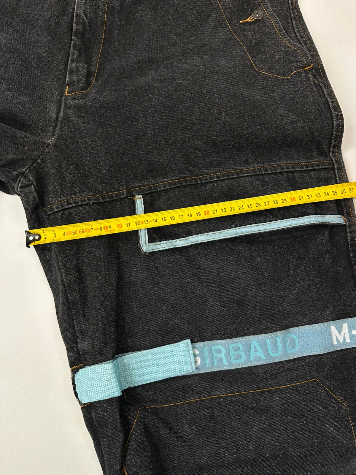 Marithé François Girbaud black and turquoise baggy denim trousers with cargo pockets and velcro details.