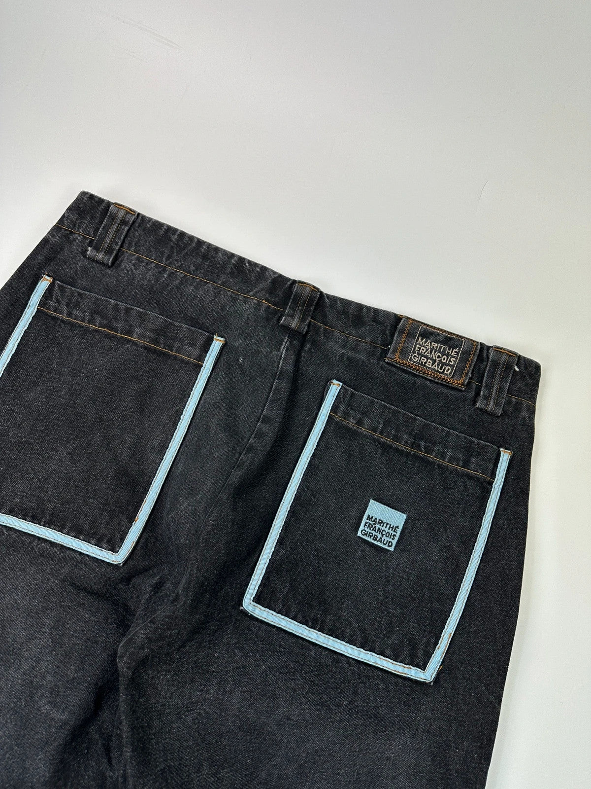 Marithé François Girbaud black and turquoise baggy denim trousers with cargo pockets and velcro details.