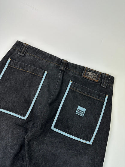 Marithé François Girbaud black and turquoise baggy denim trousers with cargo pockets and velcro details.