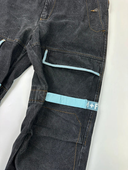 Marithé François Girbaud black and turquoise baggy denim trousers with cargo pockets and velcro details.
