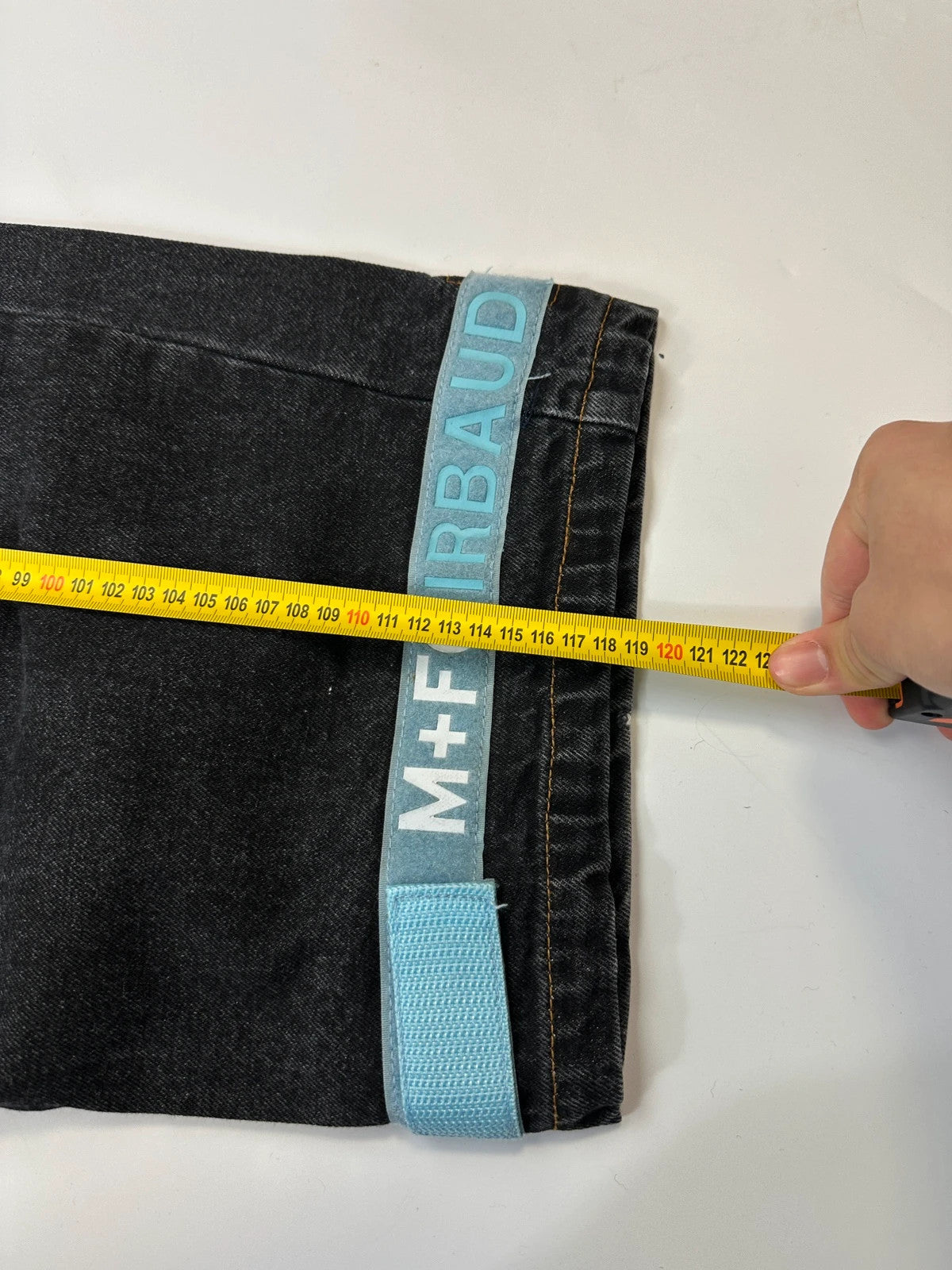 Marithé François Girbaud black and turquoise baggy denim trousers with cargo pockets and velcro details.