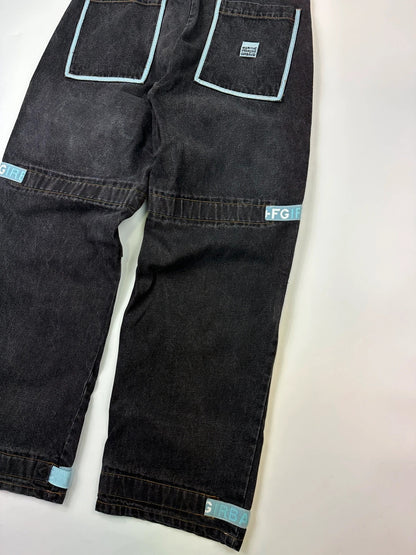 Marithé François Girbaud black and turquoise baggy denim trousers with cargo pockets and velcro details.