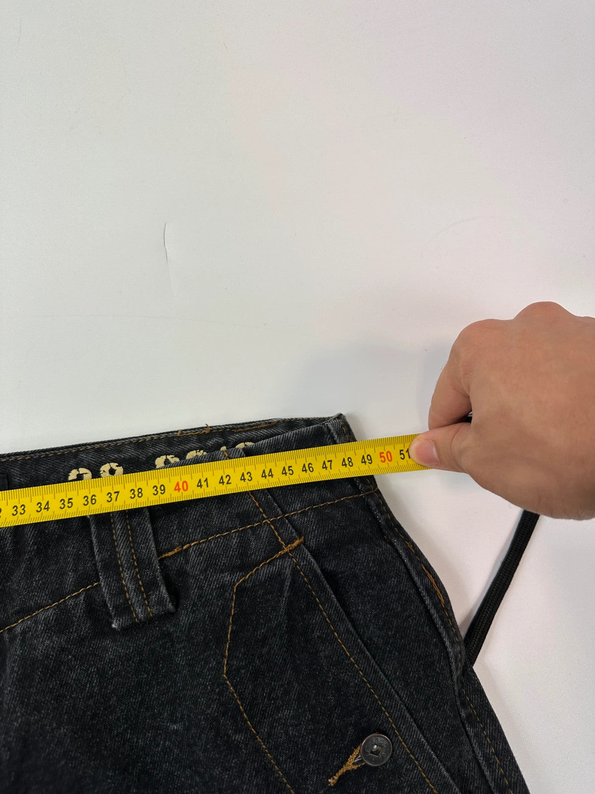 Marithé François Girbaud black and turquoise baggy denim trousers with cargo pockets and velcro details.