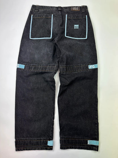 Marithé François Girbaud black and turquoise baggy denim trousers with cargo pockets and velcro details.