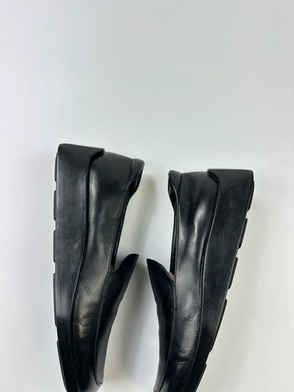 Prada black leather platform loafers with minimalist design and vintage 1998 collection details.