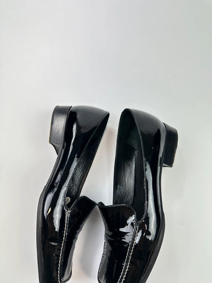 Jil Sander black patent leather loafers with shiny finish and minimalist design.