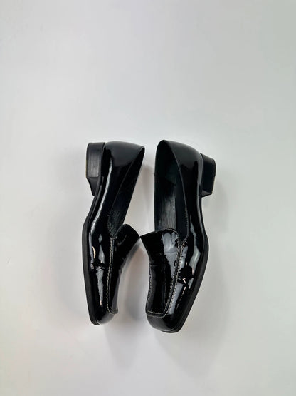 Jil Sander black patent leather loafers with shiny finish and minimalist design.