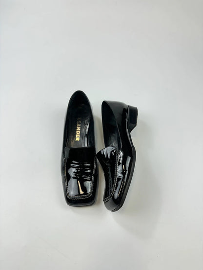 Jil Sander black patent leather loafers with shiny finish and minimalist design.