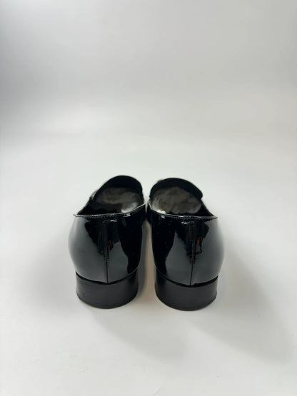 Jil Sander black patent leather loafers with shiny finish and minimalist design.