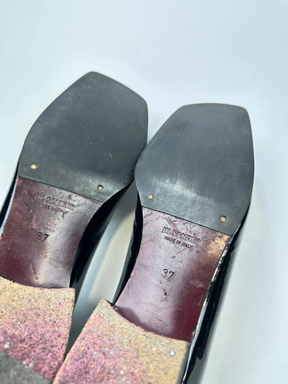 Jil Sander black patent leather loafers with shiny finish and minimalist design.