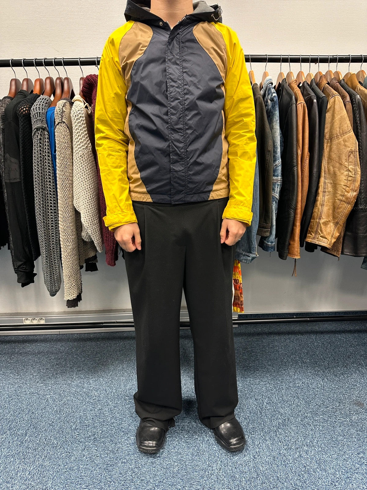 Comme Des Garçons navy and yellow block nylon hooded jacket with logo detail.