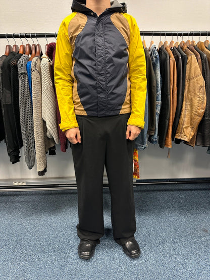 Comme Des Garçons navy and yellow block nylon hooded jacket with logo detail.
