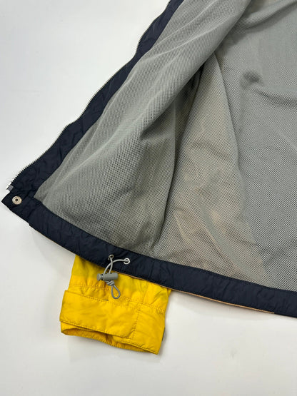 Comme Des Garçons navy and yellow block nylon hooded jacket with logo detail.