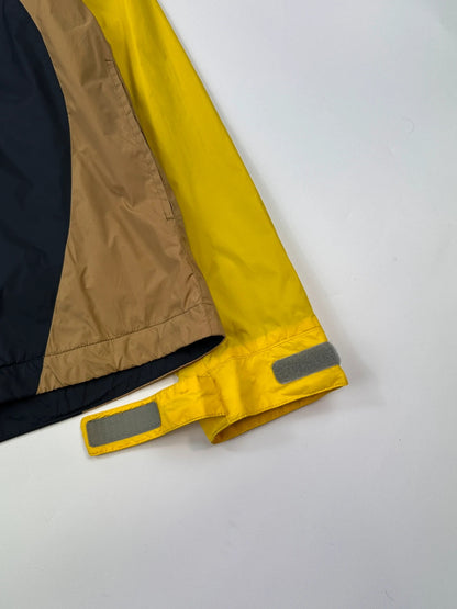 Comme Des Garçons navy and yellow block nylon hooded jacket with logo detail.