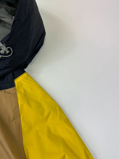 Comme Des Garçons navy and yellow block nylon hooded jacket with logo detail.