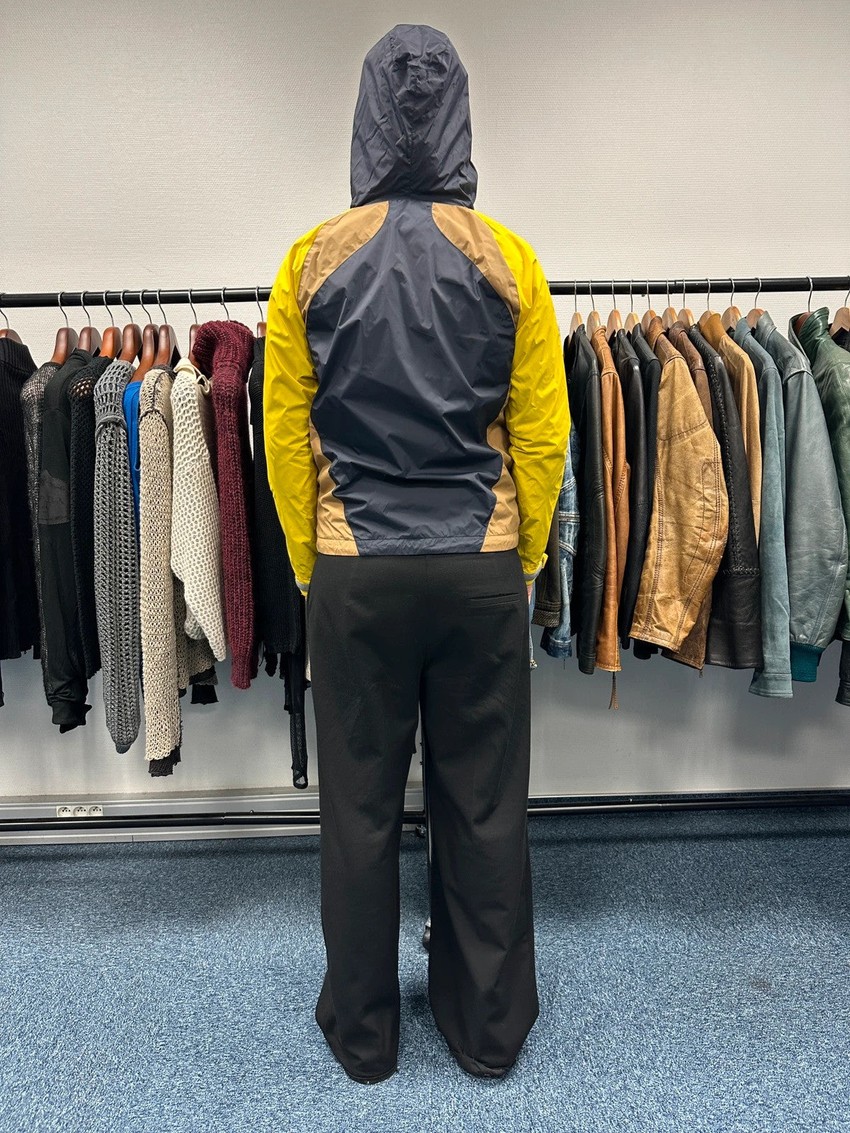 Comme Des Garçons navy and yellow block nylon hooded jacket with logo detail.