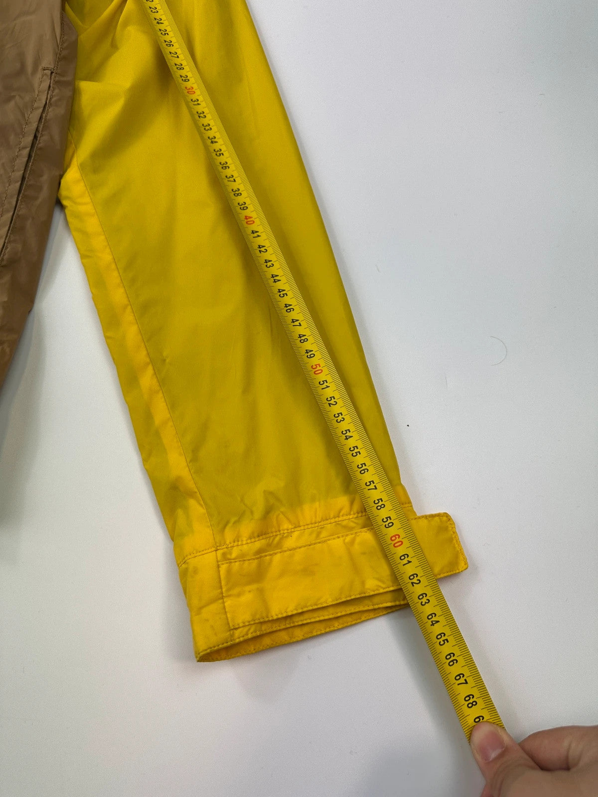 Comme Des Garçons navy and yellow block nylon hooded jacket with logo detail.