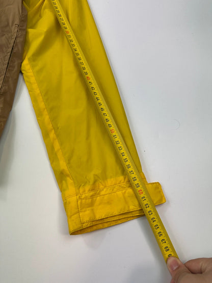 Comme Des Garçons navy and yellow block nylon hooded jacket with logo detail.