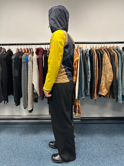 Comme Des Garçons navy and yellow block nylon hooded jacket with logo detail.