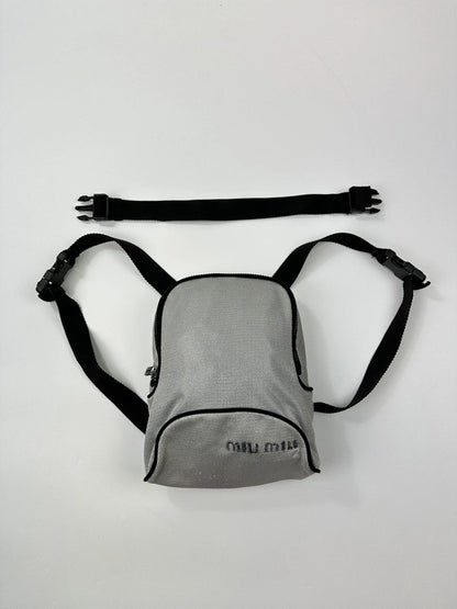 Miu Miu grey mesh 2-in-1 chest bag backpack with faded logo and minimalist design.