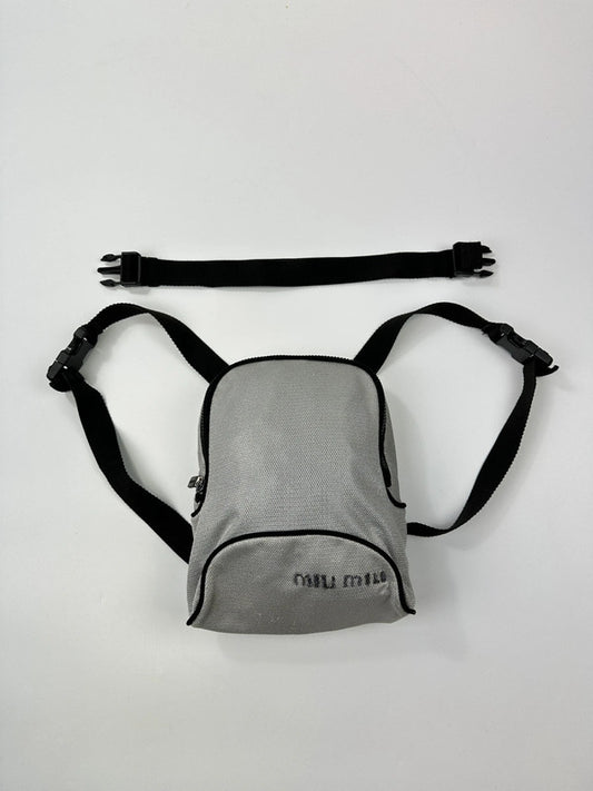 Miu Miu grey mesh 2-in-1 chest bag backpack with faded logo and minimalist design.