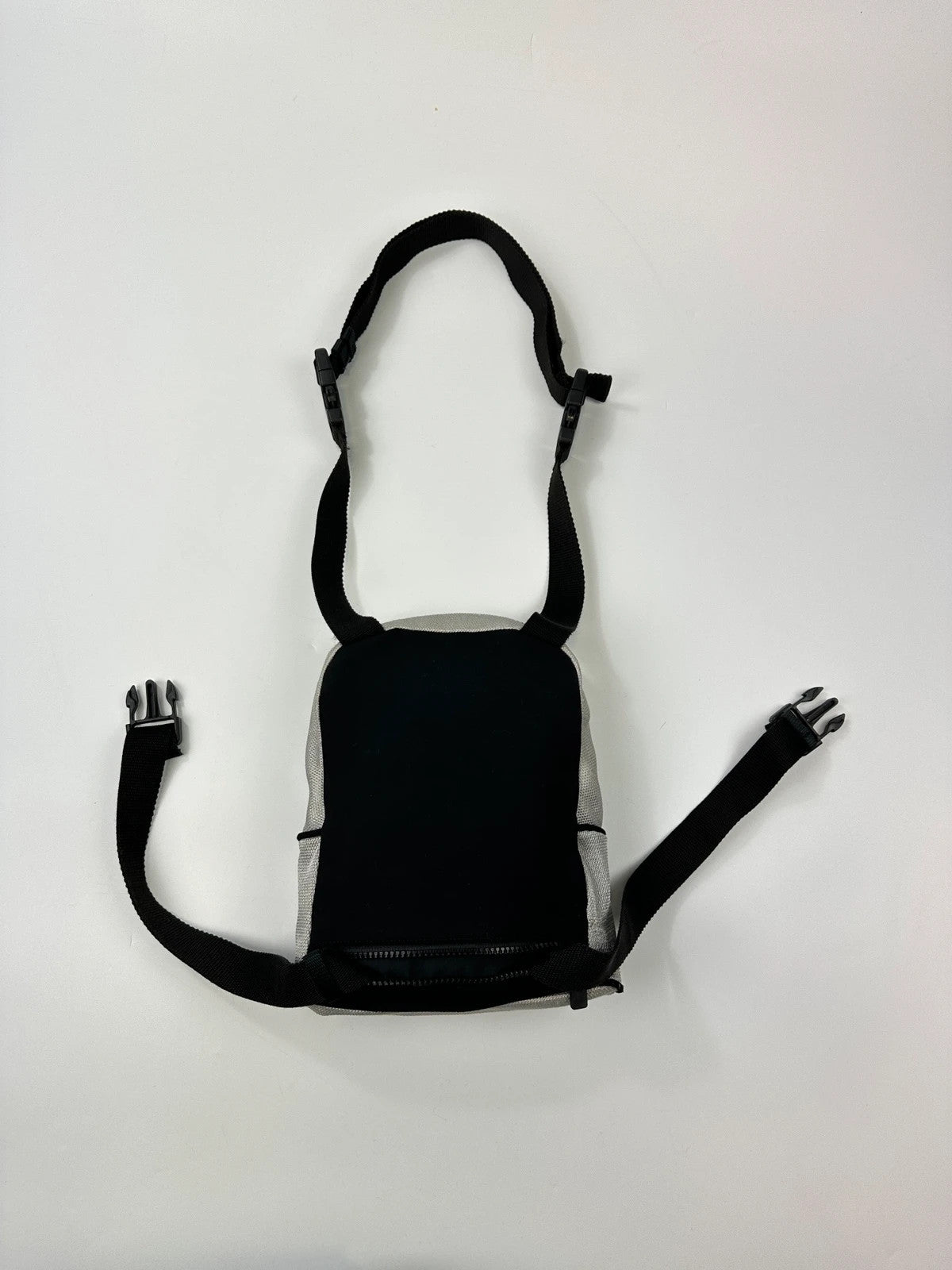 Miu Miu grey mesh 2in1 chest bag backpack, faded logo, minimalist design.