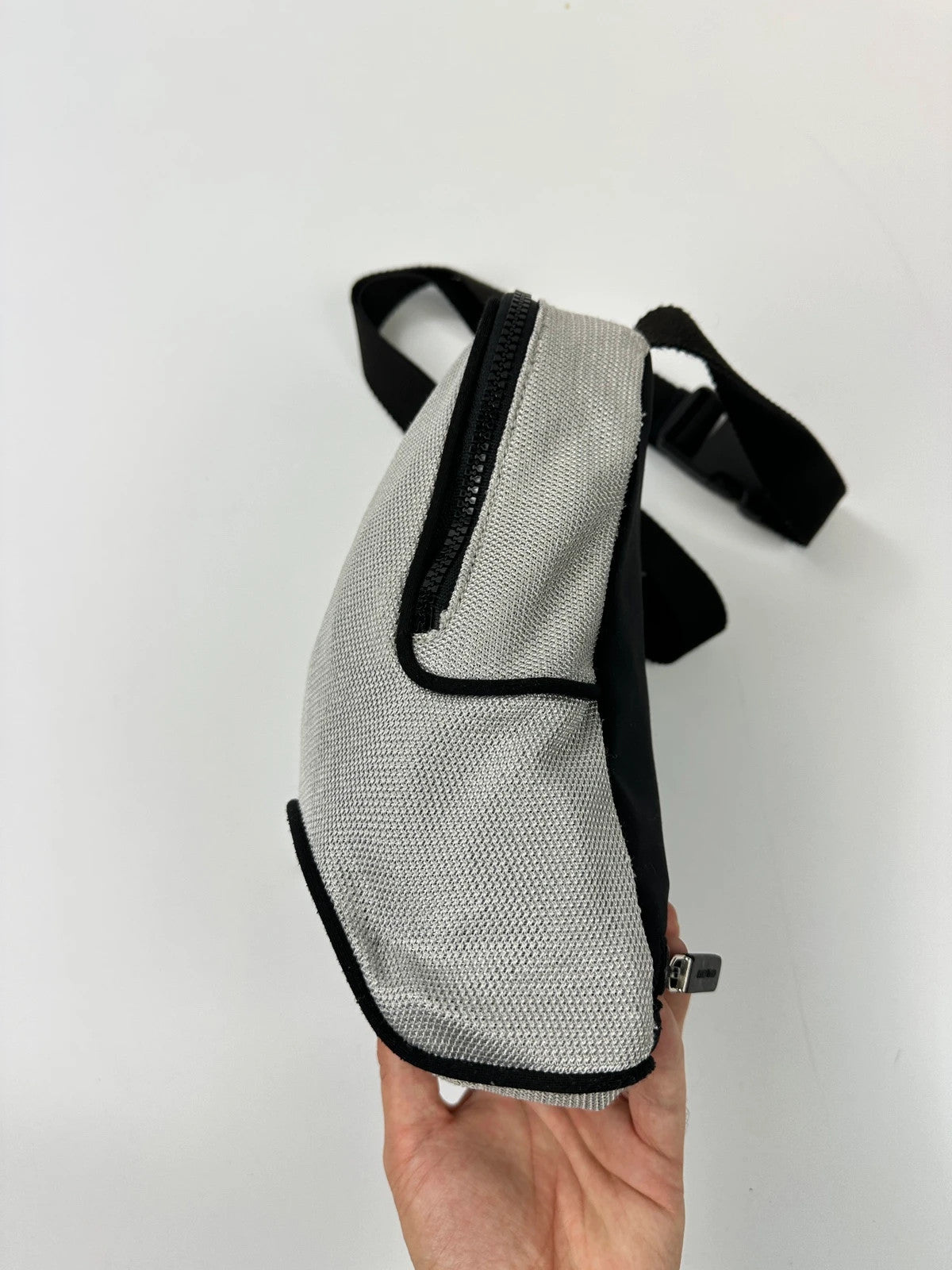Miu Miu grey mesh 2in1 chest bag backpack, faded logo, minimalist design.