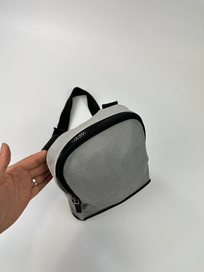 Miu Miu grey mesh 2in1 chest bag backpack, faded logo, minimalist design.