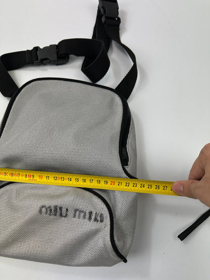 Miu Miu grey mesh 2in1 chest bag backpack, faded logo, minimalist design.