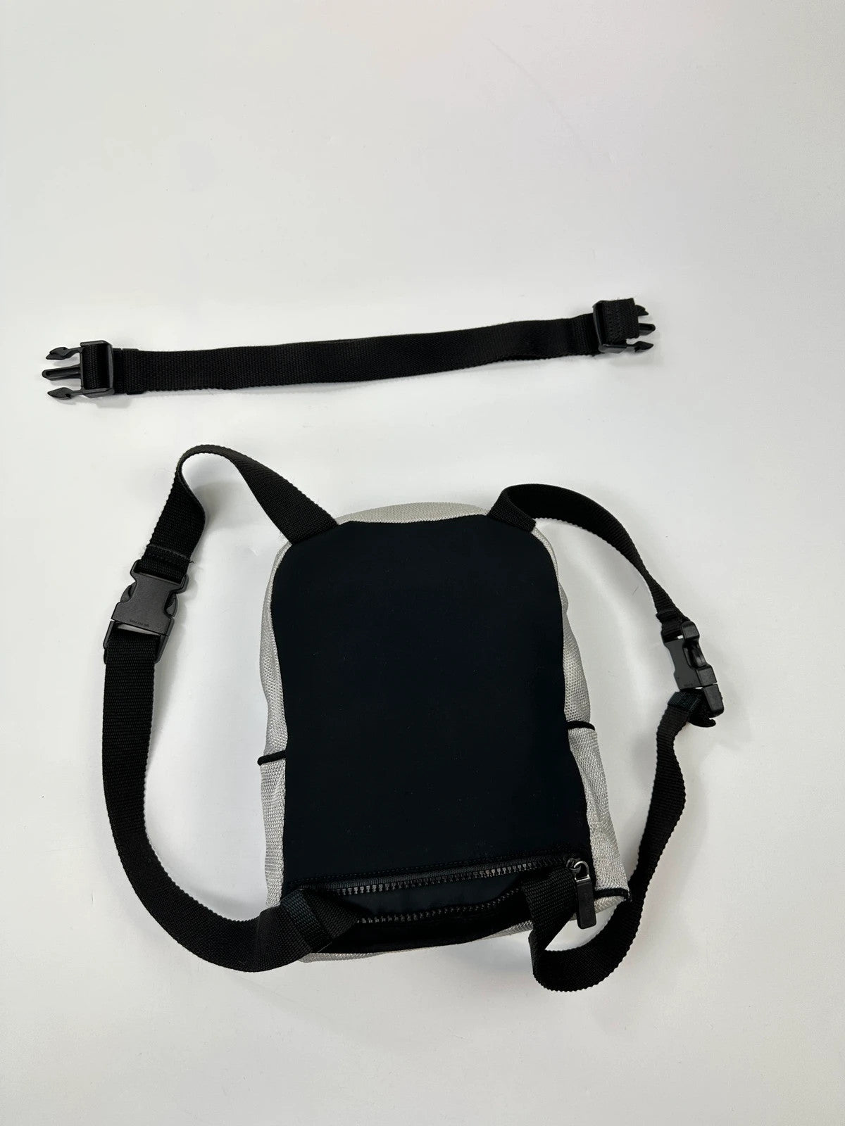 Miu Miu grey mesh 2in1 chest bag backpack, faded logo, minimalist design.