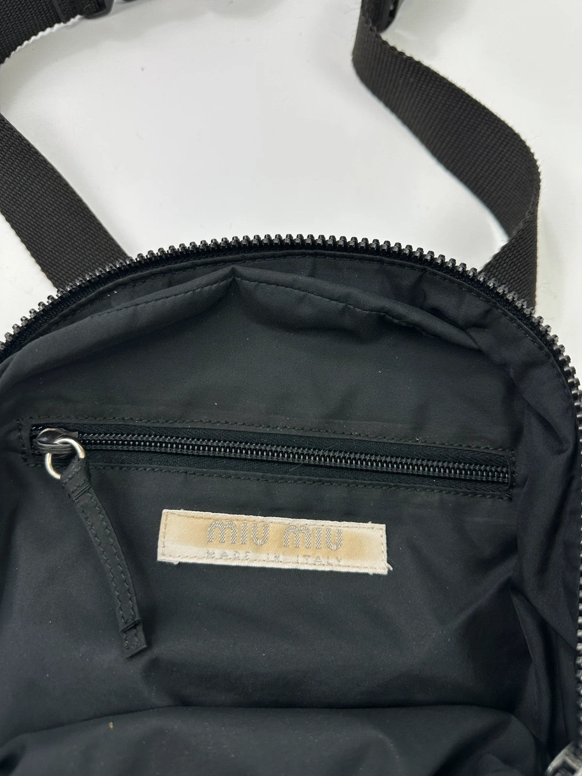 Miu Miu grey mesh 2in1 chest bag backpack, faded logo, minimalist design.