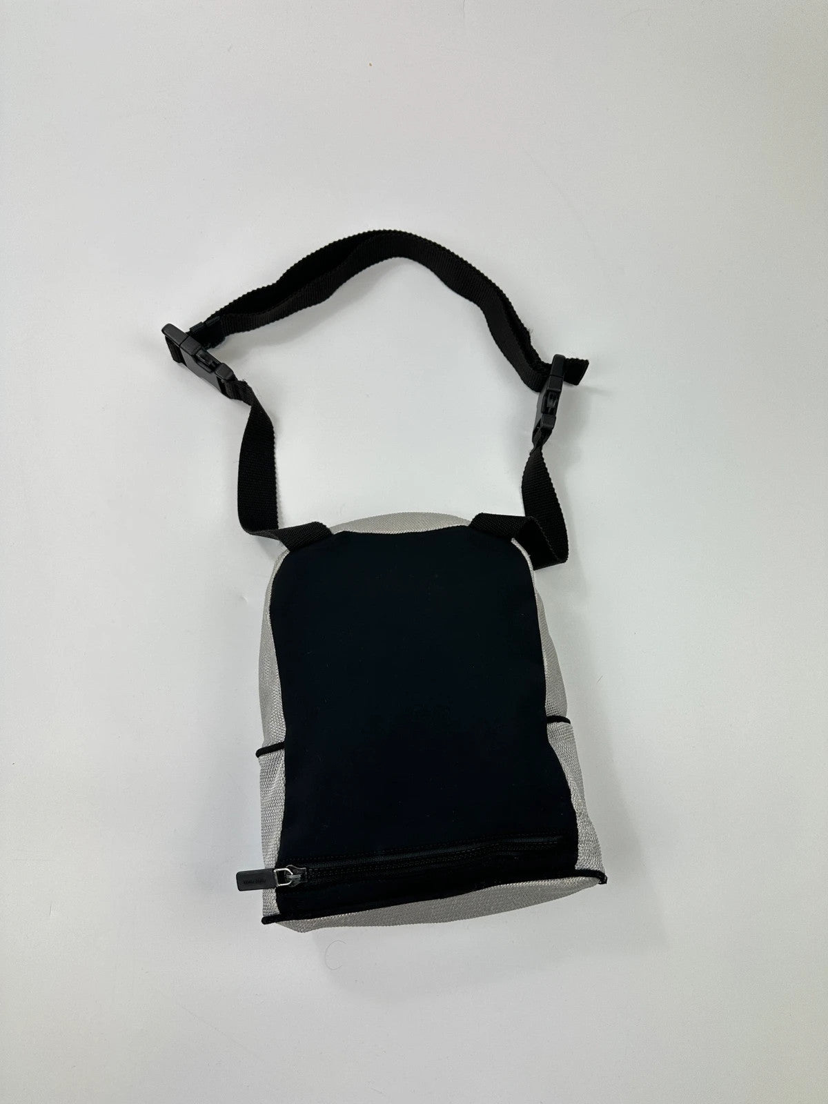 Miu Miu grey mesh 2in1 chest bag backpack, faded logo, minimalist design.