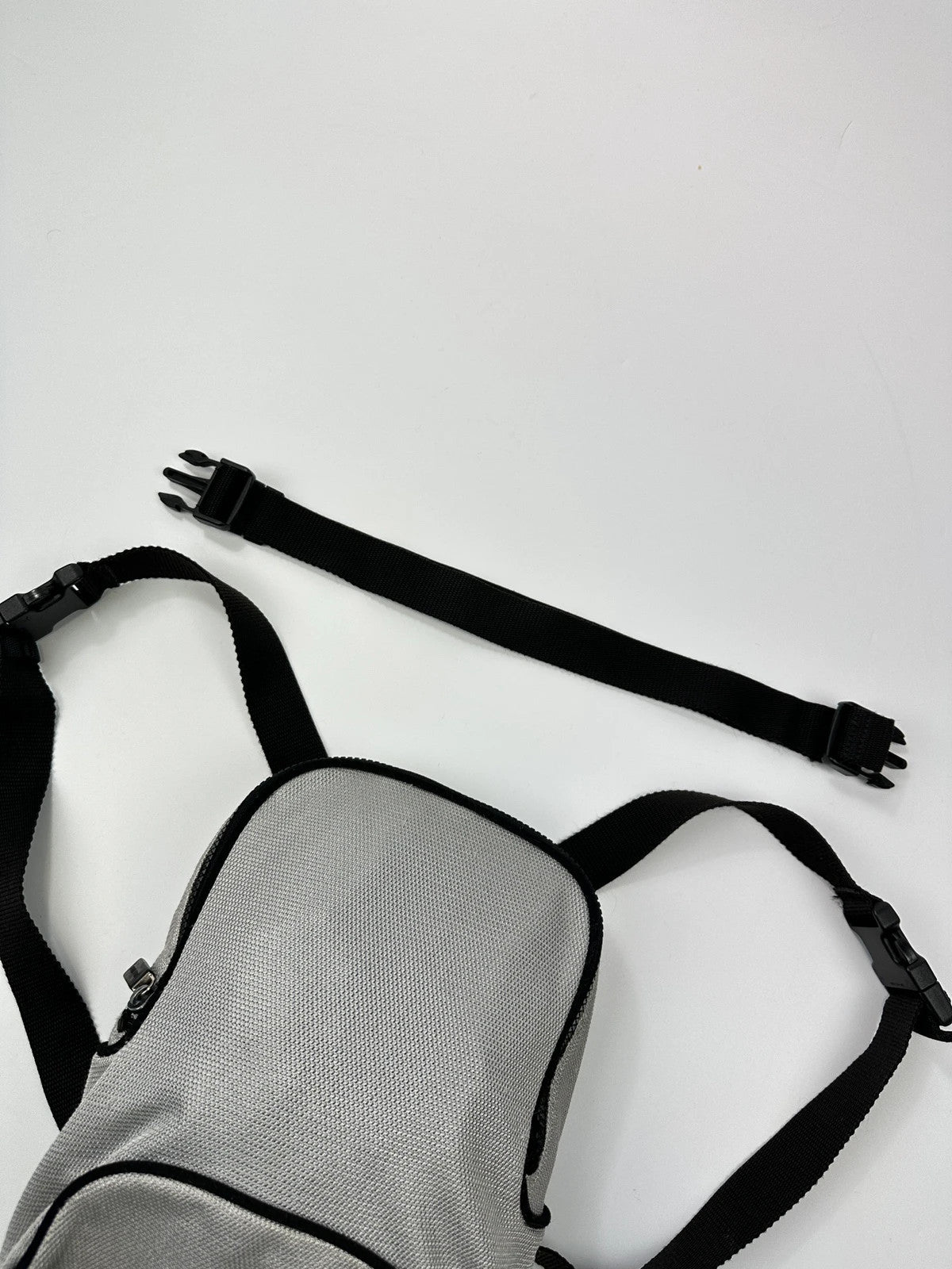 Miu Miu grey mesh 2in1 chest bag backpack, faded logo, minimalist design.