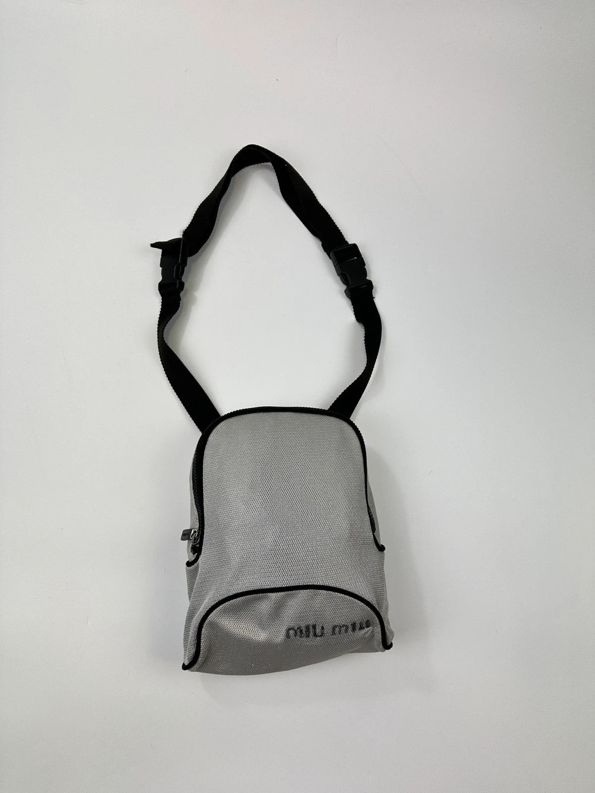 Miu Miu grey mesh 2in1 chest bag backpack, faded logo, minimalist design.