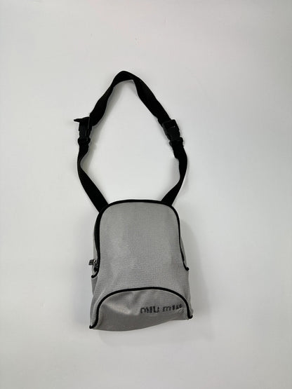 Miu Miu grey mesh 2in1 chest bag backpack, faded logo, minimalist design.